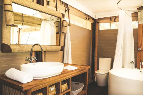a bathroom with a sink and a toilet at Luxury Riverside Glamping Tents - Adults Only Retreat in Capertee