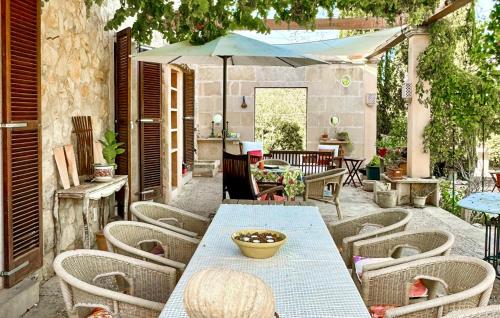 a patio with a table and chairs and an umbrella at 4 Bedroom Stunning Home In Porreres in Porreres
