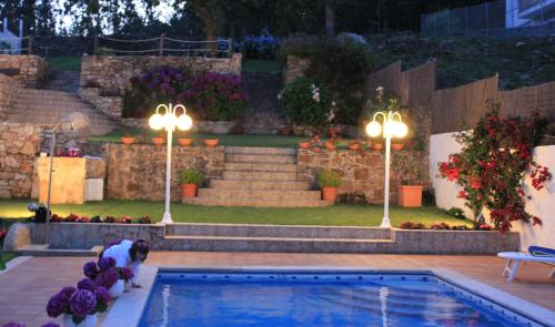 a person standing next to a swimming pool at Apartamentos Maritimo Suites-Solo Adultos in O Grove