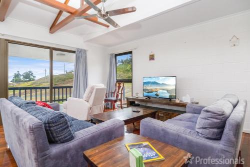 a living room with two couches and a tv at Rocky Retreat At Emu Park - 7 Connor Street Emu Park in Emu Park