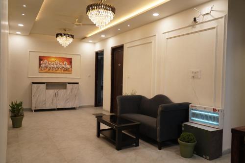 a living room with a couch and a television at The Grand View in Baijnāth