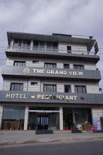 a large hotel building with a sign on it at The Grand View in Baijnāth