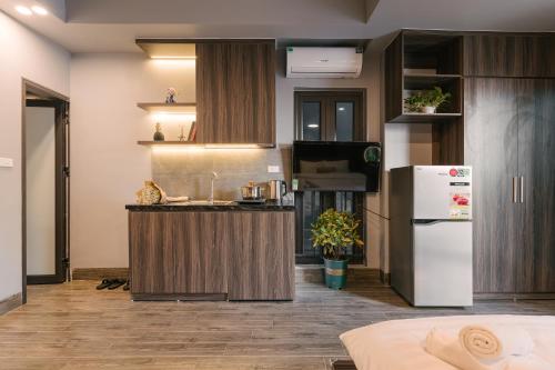 a kitchen with a counter and a refrigerator at My Home Westlake Hanoi in Hanoi