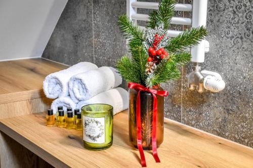 a bathroom counter with a christmas tree in a vase at Cicha Woda 300 m od Gorący Potok i Termy Szaflary in Szaflary