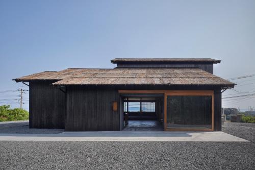 a small wooden building with a glass door at GOTO island ROKGOUTEI五島列島福江島のモダンな一棟貸ヴィラ in Goto