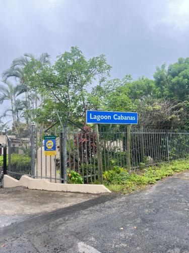 a blue sign on a fence next to a street at 10 Lagoon Cabanas Ramsgate in Margate