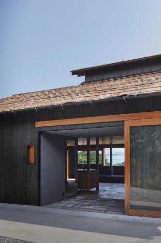 a house with a large glass door on the side of it at GOTO island ROKGOUTEI五島列島福江島のモダンな一棟貸ヴィラ in Goto