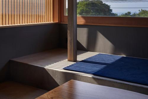 Postel nebo postele na pokoji v ubytování GOTO island ROKGOUTEI五島列島福江島のモダンな一棟貸ヴィラ