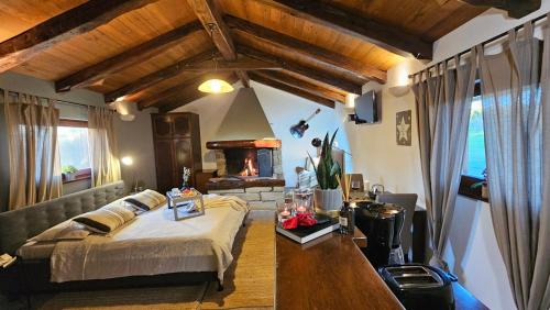 a bedroom with a bed and a fireplace at Studio apartment Cami - Cottage with a soul in Gračišće