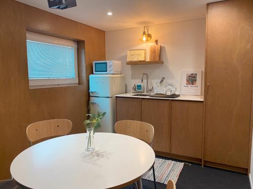 a kitchen with a white table and a refrigerator at Gurida Bupyeong in Incheon
