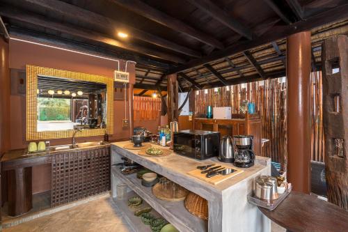a kitchen with a counter and a sink in a room at Authentic Thai Villa with Open-Air Living & Pool-Central-Huahin in Hua Hin