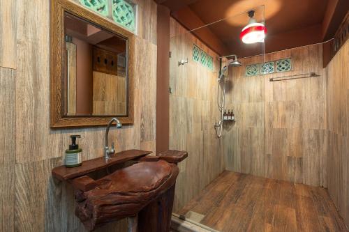 a bathroom with a sink and a mirror at Authentic Thai Villa with Open-Air Living & Pool-Central-Huahin in Hua Hin