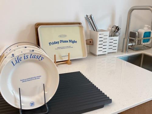 a kitchen counter with a plate and a sink at Gurida Bupyeong in Incheon