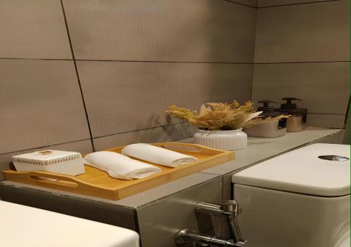 a kitchen with a cutting board with towels on a counter at D'Bayu Homestay in Donggongon