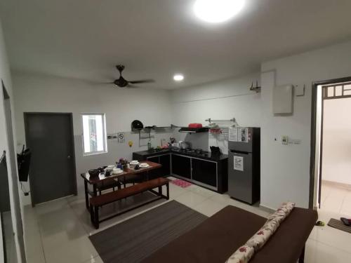 a living room with a couch and a kitchen at The Aliff Residences in Johor Bahru
