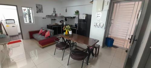 a kitchen with a table and chairs in a room at The Aliff Residences in Johor Bahru