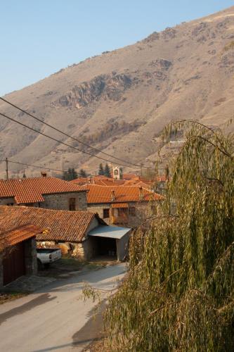 a group of houses with a mountain in the background at To Petrino Guesthouse in Agios Germanos