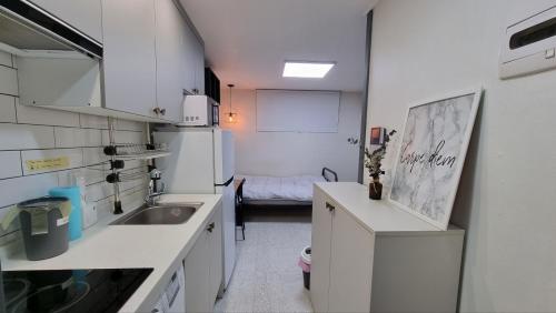 a small kitchen with a sink and a refrigerator at Petit Mejong in Seoul