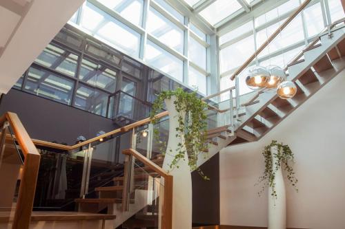 a staircase in a building with a glass ceiling at The Abdali Boulevard Hotel in Amman