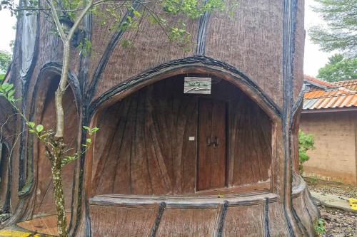 a wooden door in the middle of a tree at Tontarn Resort and Spa in Khanom
