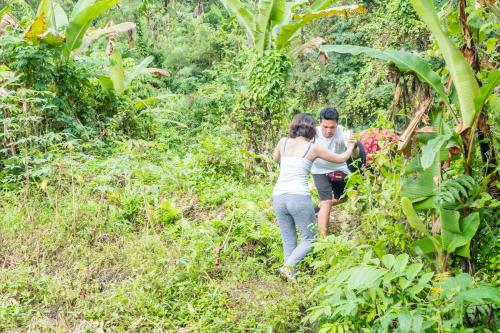 a couple walking down a trail in the jungle at The Wapa Lux Tent in Sidemen