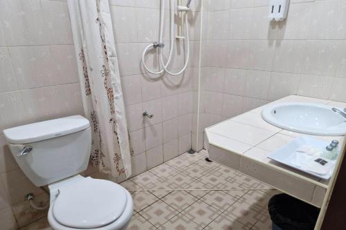 a bathroom with a toilet and a sink at Tontarn Resort and Spa in Khanom