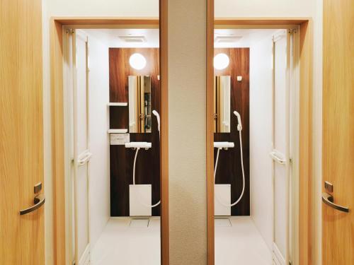 a bathroom with two sinks and a mirror at Lucky House Niseko in Kutchan