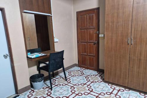a room with a desk and a chair and a door at Tontarn Resort and Spa in Khanom