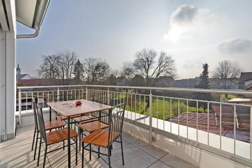 a table and chairs on a balcony with a view at White House Apartments in Kappel-Grafenhausen