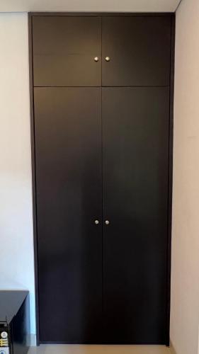 a black locker room with black cabinets at Mandhasativa Homestay in Singaraja