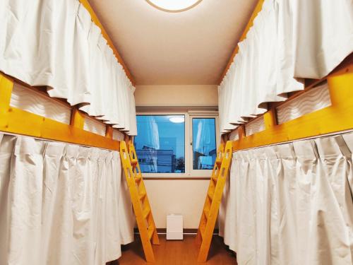 a room with bunk beds and a window at Lucky House Niseko in Kutchan