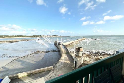 a flock of seagulls flying over the beach at T3 Duplex Vue mer 180 sur le port de Lomener in Ploemeur