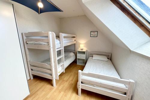 a room with two bunk beds and a ladder at T3 Duplex Vue mer 180 sur le port de Lomener in Ploemeur