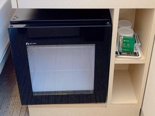 a black dishwasher in a cabinet in a room at Tmark City Hotel Sapporo in Sapporo