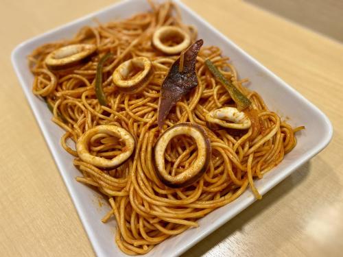 a white plate of spaghetti with a fork in it at Tmark City Hotel Sapporo in Sapporo
