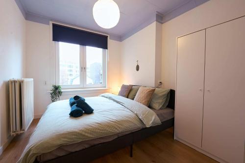 a bedroom with a bed with a stuffed animal on it at City Suite Number 4 in Eindhoven