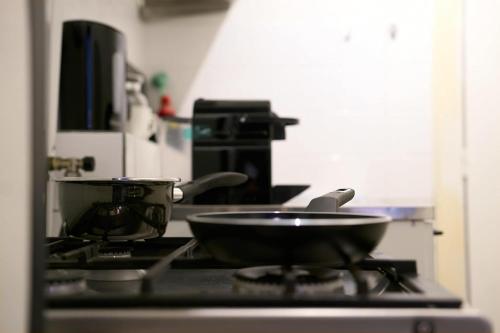a frying pan on top of a stove in a kitchen at City Suite Number 4 in Eindhoven