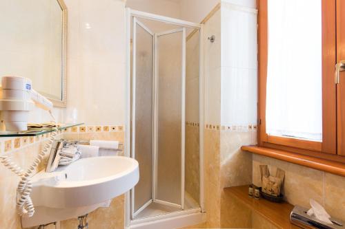 a bathroom with a sink and a shower at Hotel Arco Di Travertino in Rome