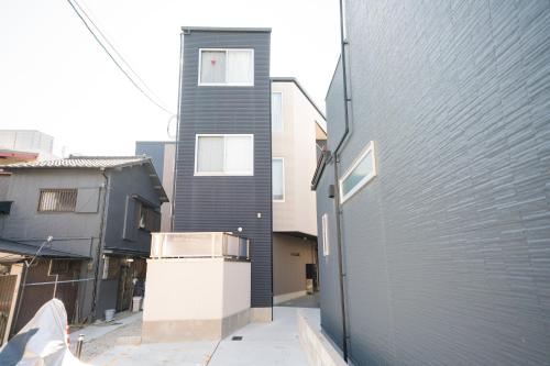 a house with a refrigerator in front of a building at フォルモント寺田町204 in Osaka