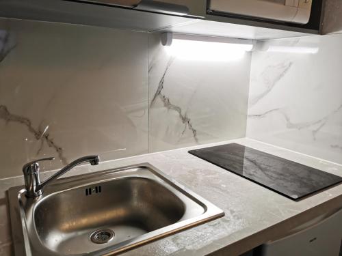 Kuchyň nebo kuchyňský kout v ubytování Appart Hotel La Defense