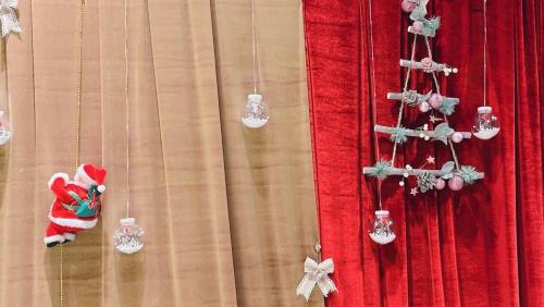a red curtain with christmas decorations on it at Yangpyeong Forest Live Pension in Sŏwŏn-mal