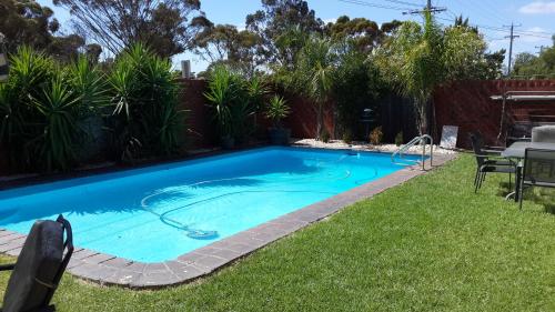 a swimming pool in the backyard of a house at Zero Inn Motel in Nhill