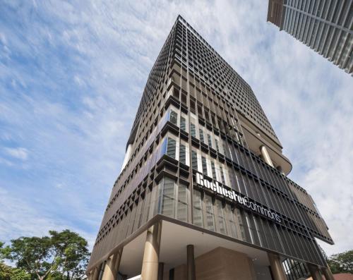 a tall building with a sign on the side of it at Citadines Connect Rochester Singapore in Singapore