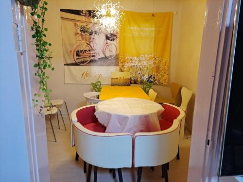 a table and chairs in a room with a yellow wall at 복층형 하우스 in Daejeon