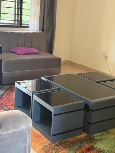a living room with a couch and a coffee table at Cloud Air in Kampala