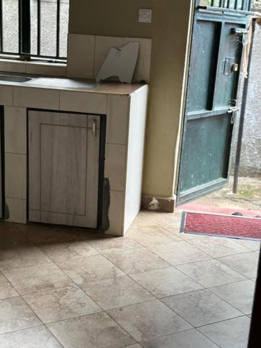 a kitchen with a door and a counter with a door at Cloud Air in Kampala