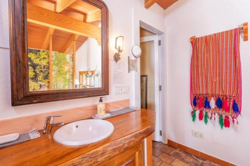 a bathroom with a sink and a mirror at Finca Tito y Yaya in Alcudia