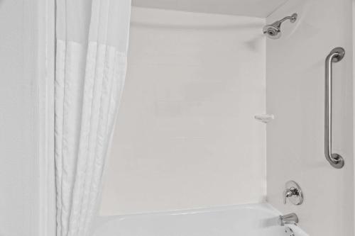 a bathroom with a shower with a shower curtain at Comfort Inn & Suites near Tinley Park Amphitheater in Tinley Park