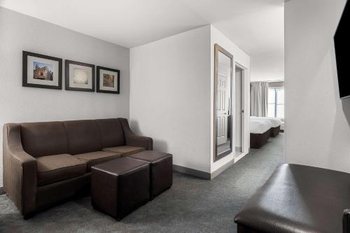 a living room with a couch and a bed at Comfort Inn & Suites near Tinley Park Amphitheater in Tinley Park