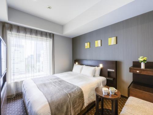 a hotel room with a bed and a window at Akihabara Washington Hotel in Tokyo